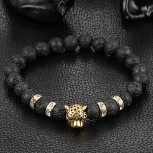 Handgjort armband guld leopard svarta lavastenar